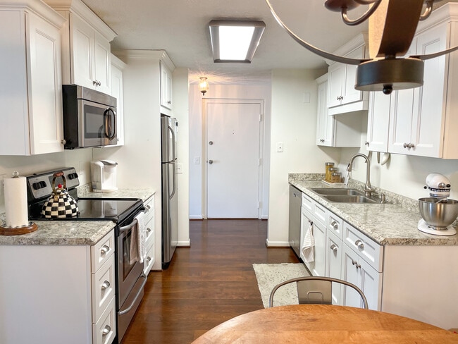 Kitchen with fridge, microwave, dishwasher, oven, and stove. - 29 Great Wood Ct Unit 8