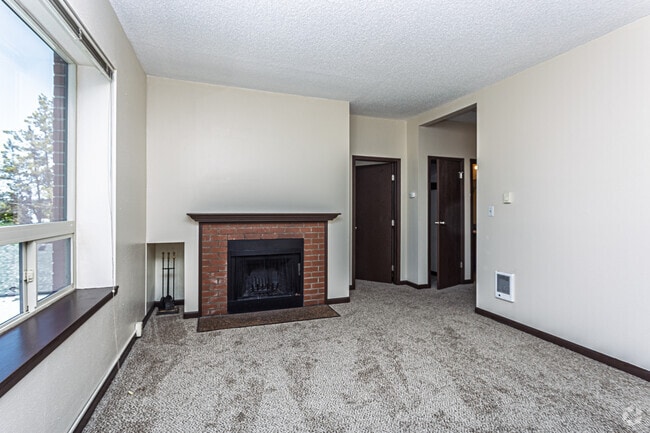 Spacious living room with cozy wood-burning fireplace - Julia Manor