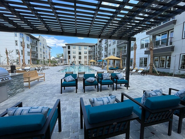 Experience ultimate relaxation in this luxurious outdoor pool area, perfect for unwinding. - The Juliette