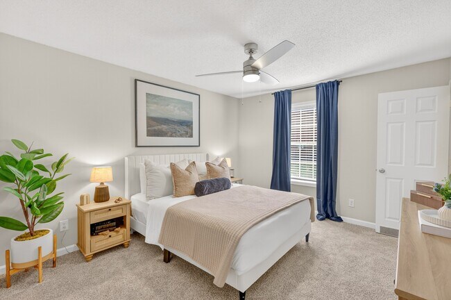 Bright bedroom with modern ceiling fan at Saddlebrook Apartments