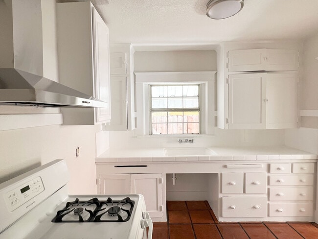 Freshly painted kitchen and polished tile floors. - 1817 E 8th St