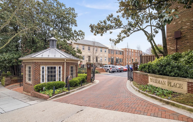 Gated entry to apartment complex with 24-hour security. - 1636 Beekman Pl NW Townhome