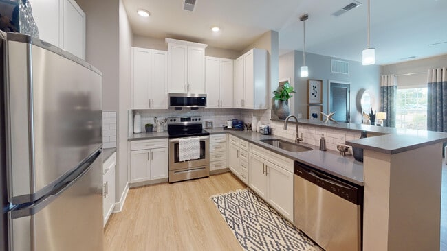 The Union Chapel kitchen features sleek stainless steal appliances, including a dishwasher, glasstop stove, and microwave.