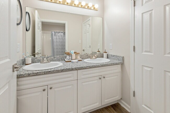 Elegant Bathroom with Double Vanity Sinks and Gold Accents