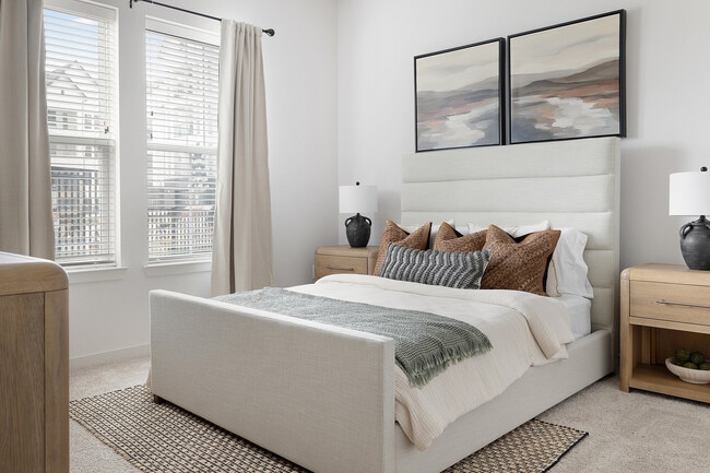 Experience serenity in this beautifully designed modern bedroom, complete with chic accents.