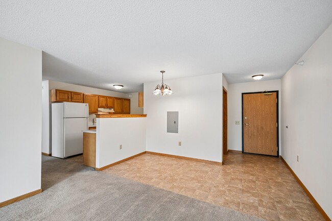 Step into the spacious living area at Mill Pond Apartments, where modern comfort meets functionality. Enjoy the open dining space and convenient kitchen layout. Schedule a tour today to see your future home!