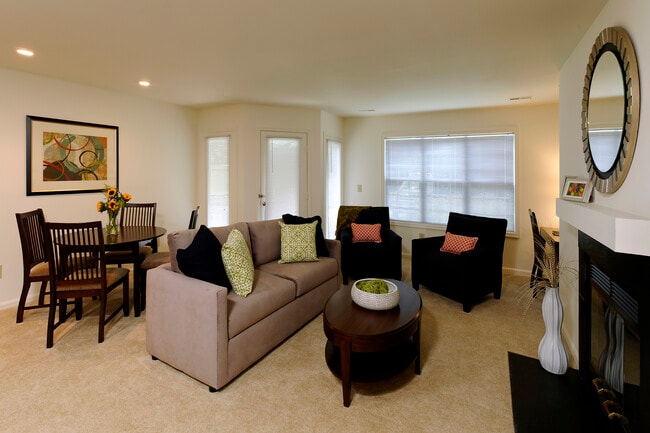 Carpeted dining and living area with fireplace
