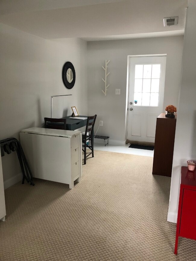 Private entrance from the backyard, desk area with bookshelf. - 7922 Fitzroy St