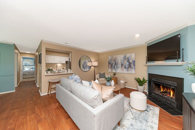 Spacious living room with hardwood-style flooring & fireplace
