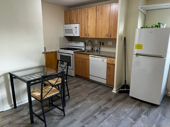 kitchen with fridge, microwave, dishwasher, gas range, granite counters - 1420 N St NW Unit #610