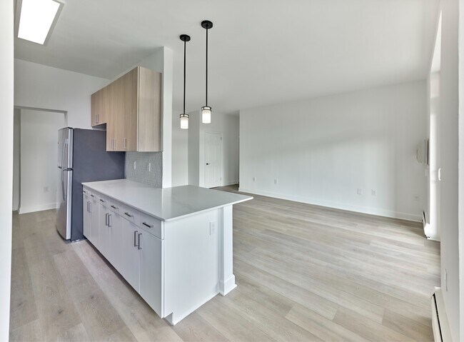 Bright and modern kitchen with quartz countertops and stainless steel appliances at Crestwood Apartments in Wayne, PA