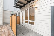Private patio space with wood privacy panels and direct home access—perfect for fresh air and outdoor relaxation.
