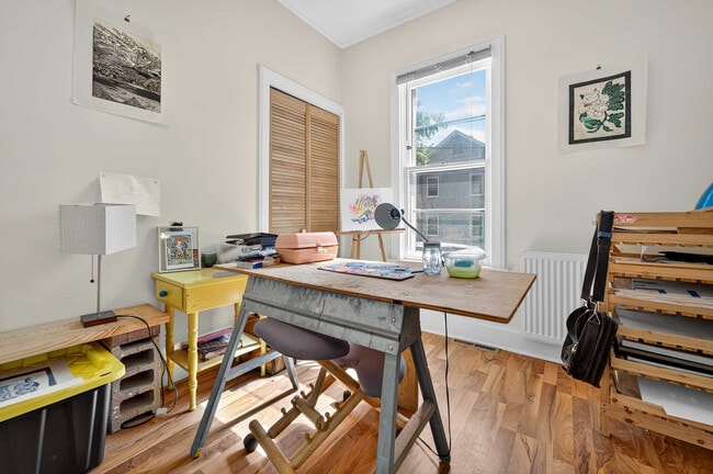Bedroom #1 featuring two closets and ceiling fan. This is an East facing morning sun window. - 302 Van Deusen St Unit #1