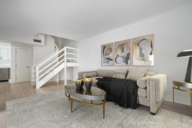 Enjoy a spacious living room in yout two story townhome - Four Quarters