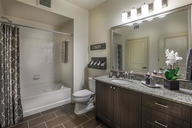 Spa-like bathrooms feature framed mirrors and oversized tubs