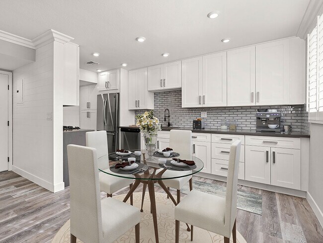 Hardwood floored dining room with view of gorgeous tiled kitchen.