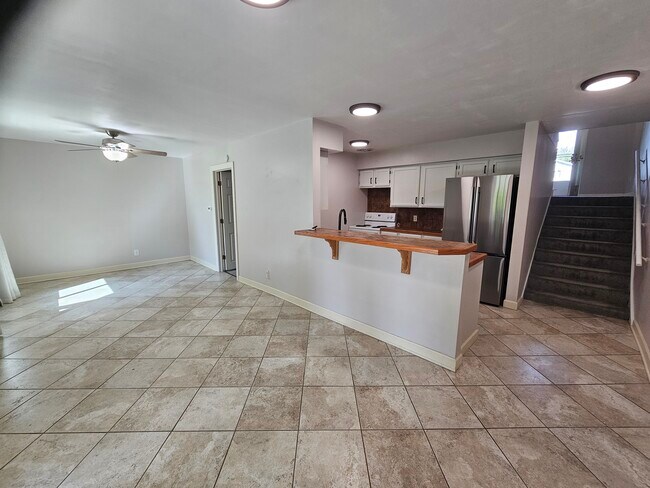 Open concept kitchen,eating, living space with walkout to patio, backyard and lake