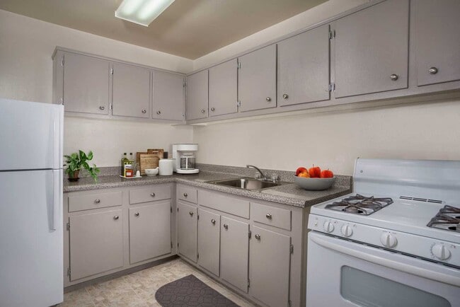 Kitchen with gas range at Carrollon Manor Apartments in New Carrollton, MD