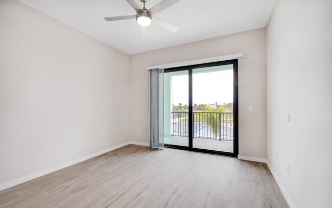 Imperial Crossing Luxury Apartment Homes unit showing a bedroom with patio/balcony.
