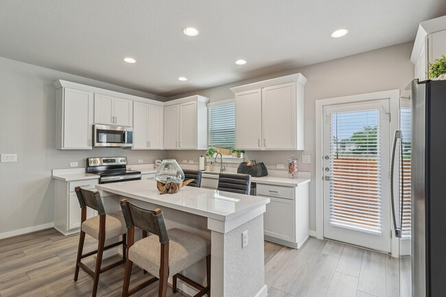 Spacious Kitchen with Island and Stainless Steel Appliances