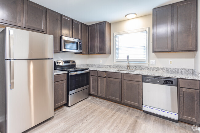 Modern Kitchen with Stainless-Steel Appliances + Granite Countertops - Legacy at Tech Center Apartments