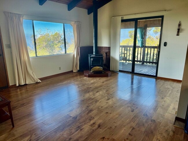 Photo - Experience comfort in this charming 3 bed, 2 bath rental home with a wood-burning stove, sunken j...