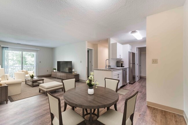 Renovated Package I dining and living room with hard surface flooring