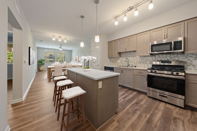 Kitchens are complete with quartz countertops and custom tile backsplash.