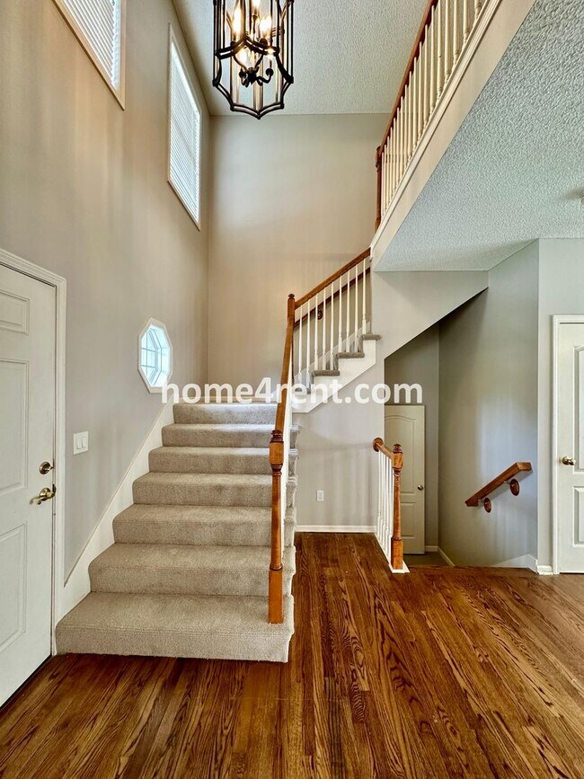 Photo - Beautiful Four-Bedroom Home with Three Car Garage, Wood Floors, Finished Basement and a Fenced Ya...