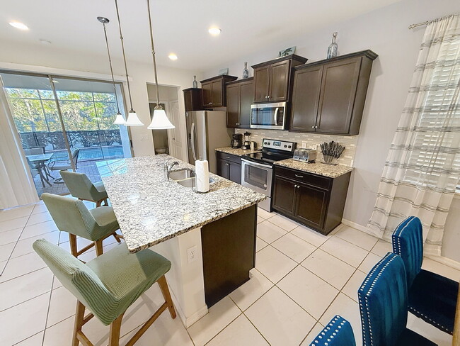 Photo - Welcome home to the fully furnished 5-bedroom, 5.5-bathroom private pool home located in Windsor ...