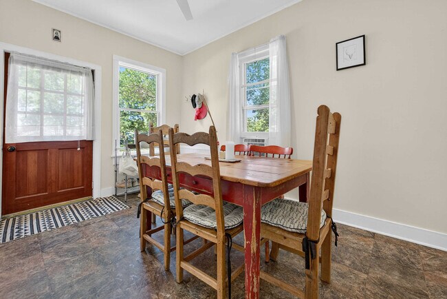 Dining room with South and West facing windows and ceiling fan. - 302 Van Deusen St Unit #1
