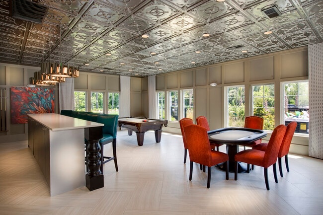 Photo of recreation room with card table, pool table, and serving bar. - Brookview at Citrus Park