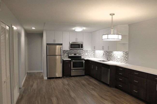 Spacious kitchen with white quartz countertops - the Cathryn Apartments