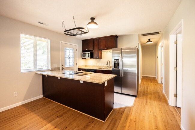 Kitchen. Granite countertops, soft close drawers and cupboards, new SS Fridge, ceramic tile floor - 8717 NE Webster St Unit B