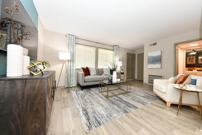 Spacious living room with hardwood-style flooring - Kinley at the Park Apartments