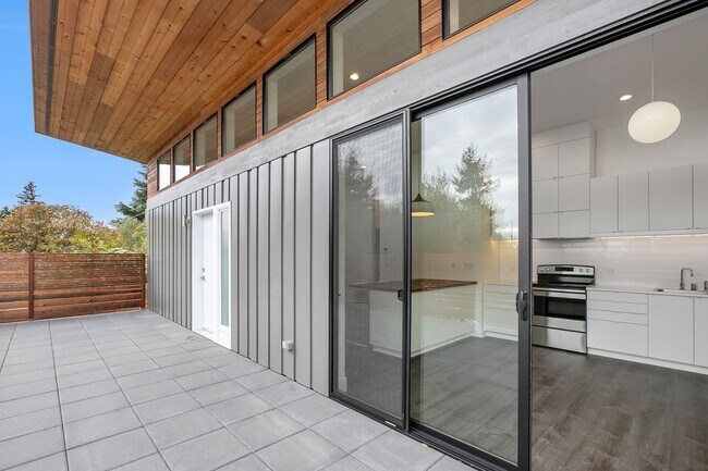 Large glass sliders open to the kitchen - 9817 20th Ave SW