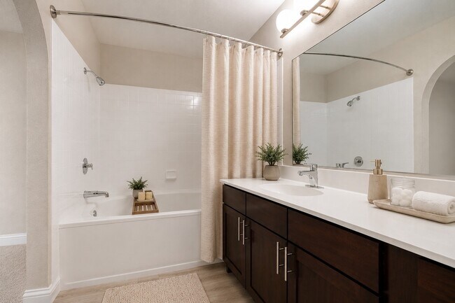 Indulge in the elegance of this spacious bathroom at Invitational, featuring a modern vanity, ample storage, and a relaxing bathtub. A perfect blend of comfort and style awaits. Schedule your visit today and elevate your living experience!