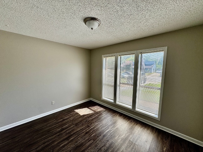 Photo - Charming 3BR/2BA Near Southwind | Soaring Vaulted Ceilings, Brick Fireplace & Fenced Yard