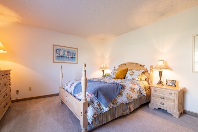 A peaceful and comfortable bedroom space in the two-bedroom apartment at Cedar Crest Apartments.