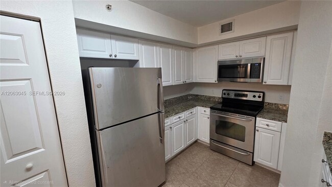 Building Photo - 6768 Heritage Grande Unit 208