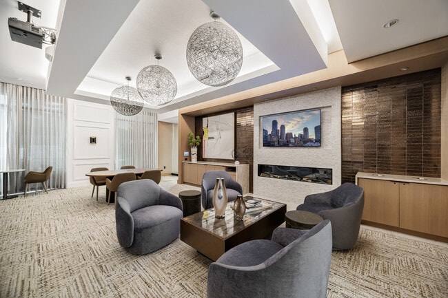 Media lounge offering both lounge and theater seating and multiple TVs