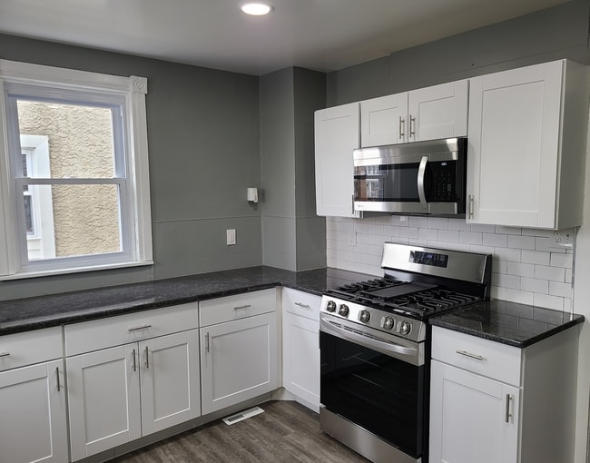 Photo - Twin home with updated kitchen, washer/dry on first floor, private back yard and porch.