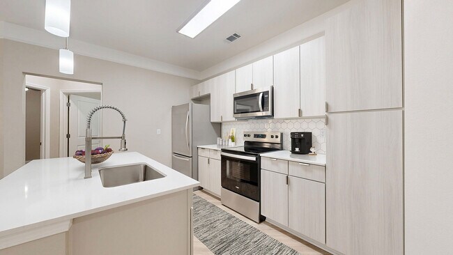 Newly Renovated Kitchen with Quartz Countertops - The Retreat at Quail North Apartments