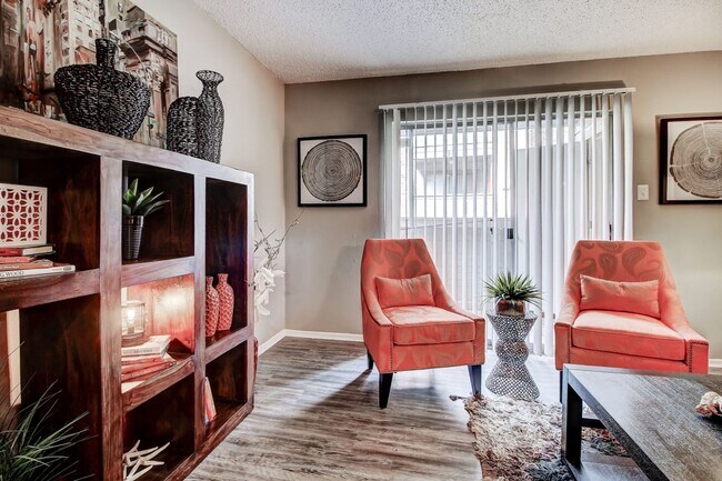 Large living room with lots of natural light and hardwood style floors