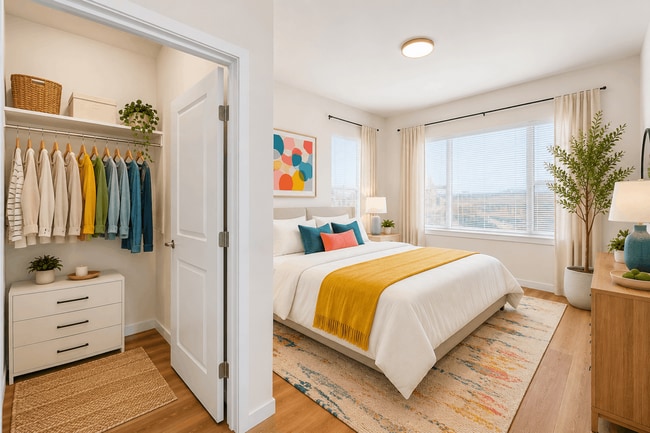 Spacious primary bedroom with a walk-in closet, large windows, and modern finishes at 27 West Apartments.
