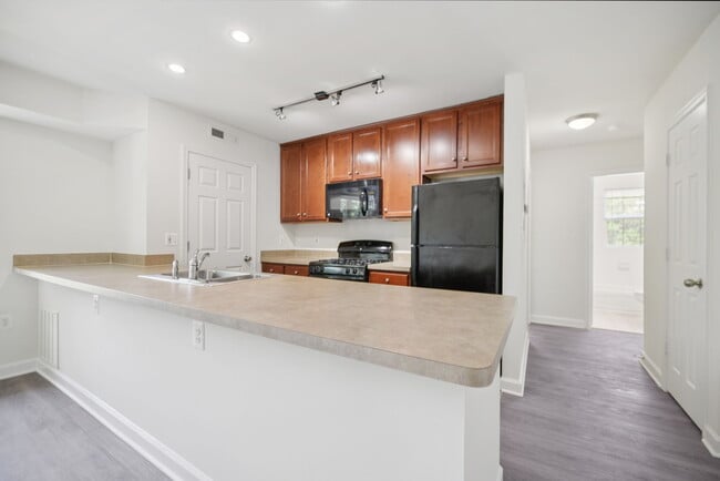 Gourmet designer kitchens with stainless steel appliances, track lighting, quartz countertops, and Italian kitchen cabinetry