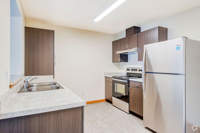 Kitchen with Stainless Steel Appliances - The Orchard Apartments