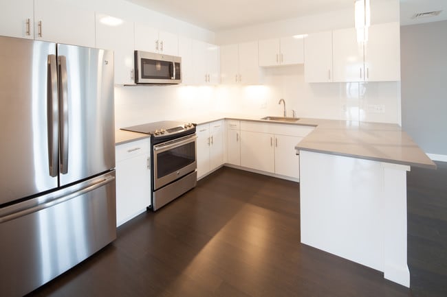 Each Unit with Quartz Countertops and Peninsula Seating