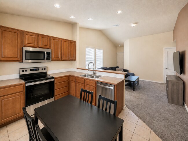 Photo - Bright Open-Concept Home with Fenced Yard, Double Garage & Community Amenities
