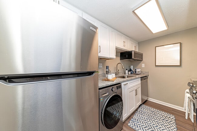 Kitchen with granite counters and modern cabinetry - The Fitzgerald